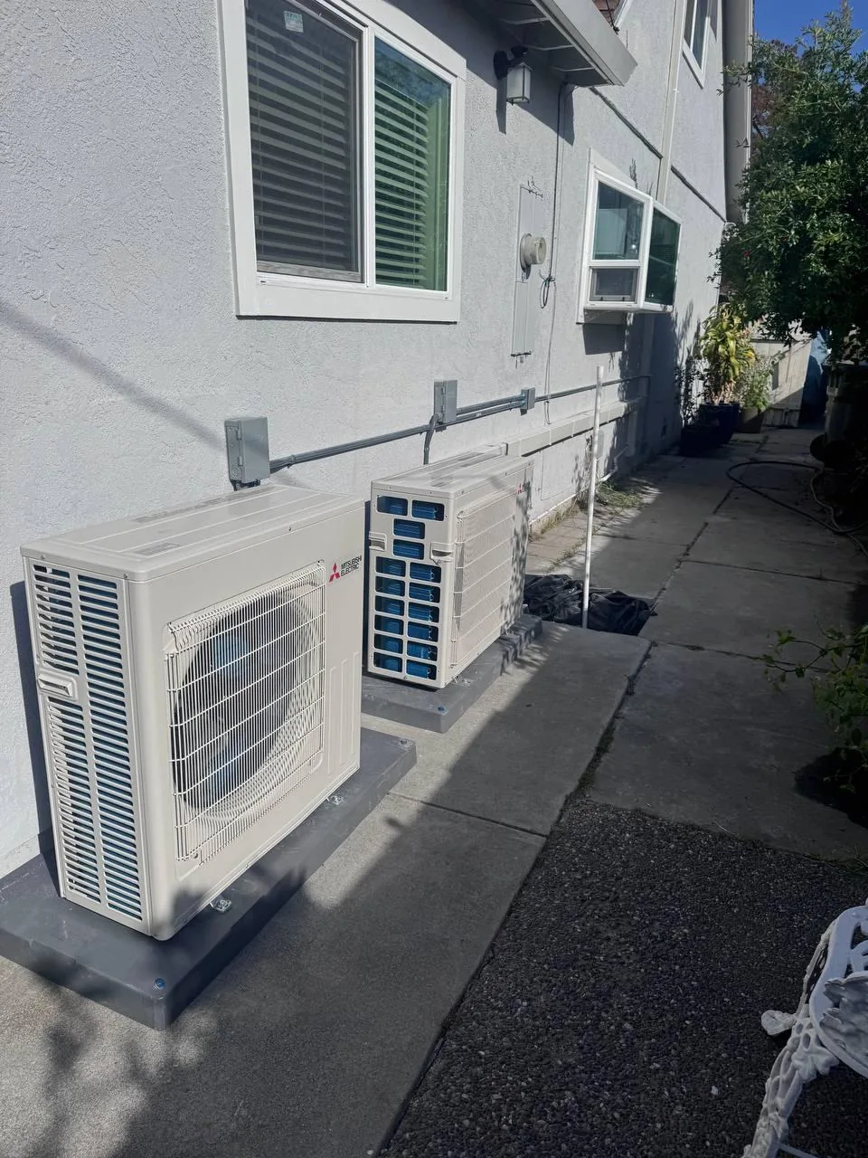 Two Mitsubishi outdoor units