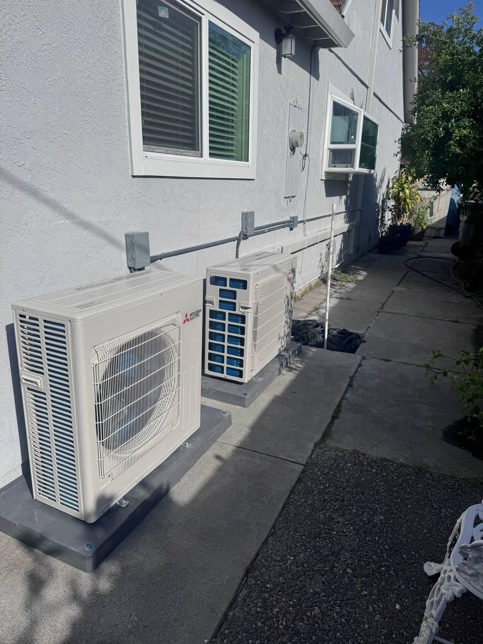 Two Mitsubishi outdoor units