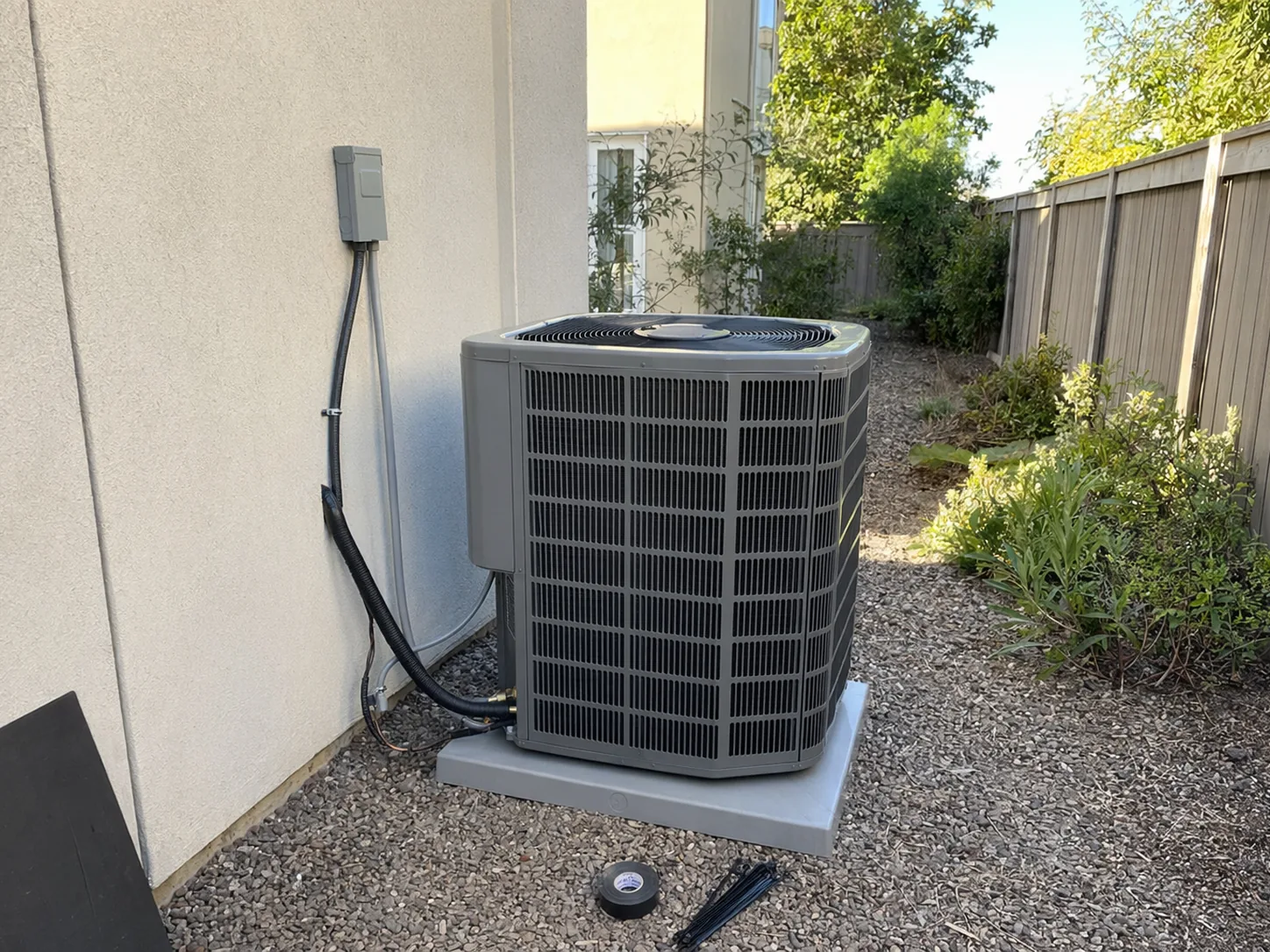New residential AC condenser installed beside a home in Dublin, Bay Area