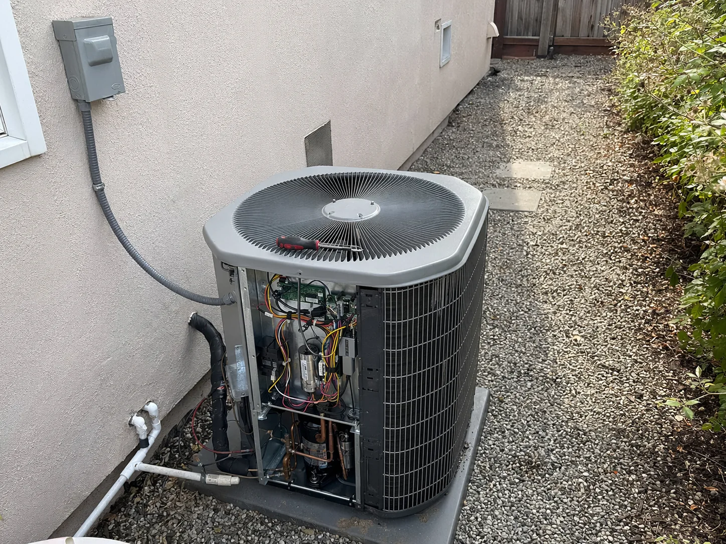 New residential AC condenser installed beside a home in San Jose, Bay Area