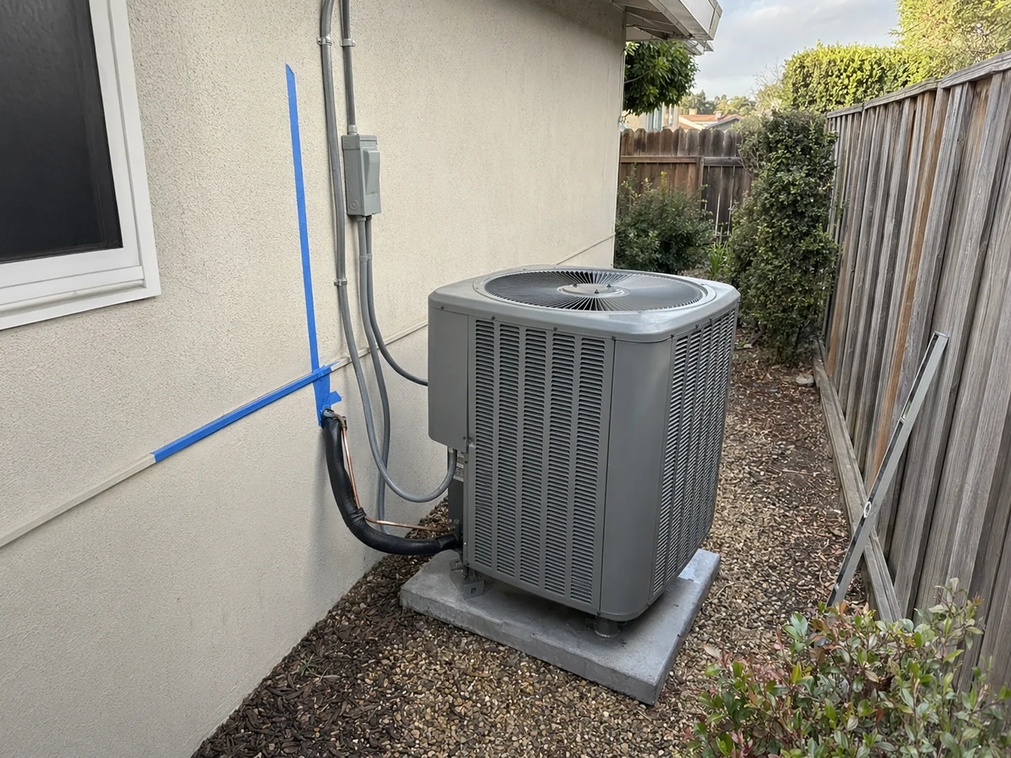 New residential AC condenser installed beside a home in Union City, Bay Area