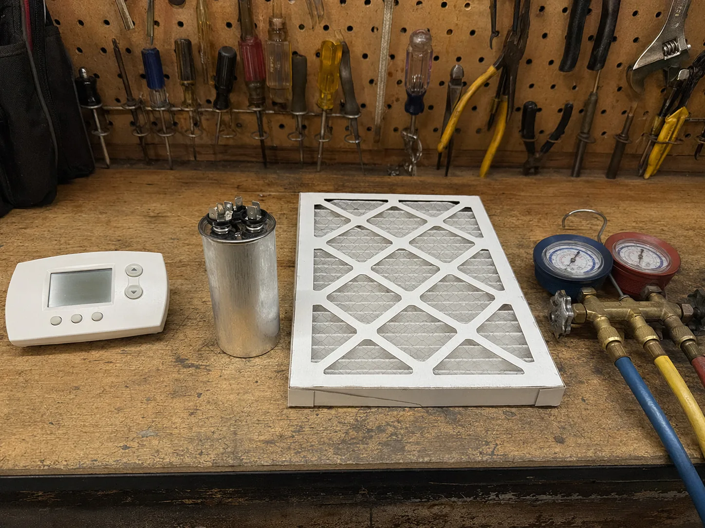 Technician's clipboard and HVAC diagnostic tools on a workbench
